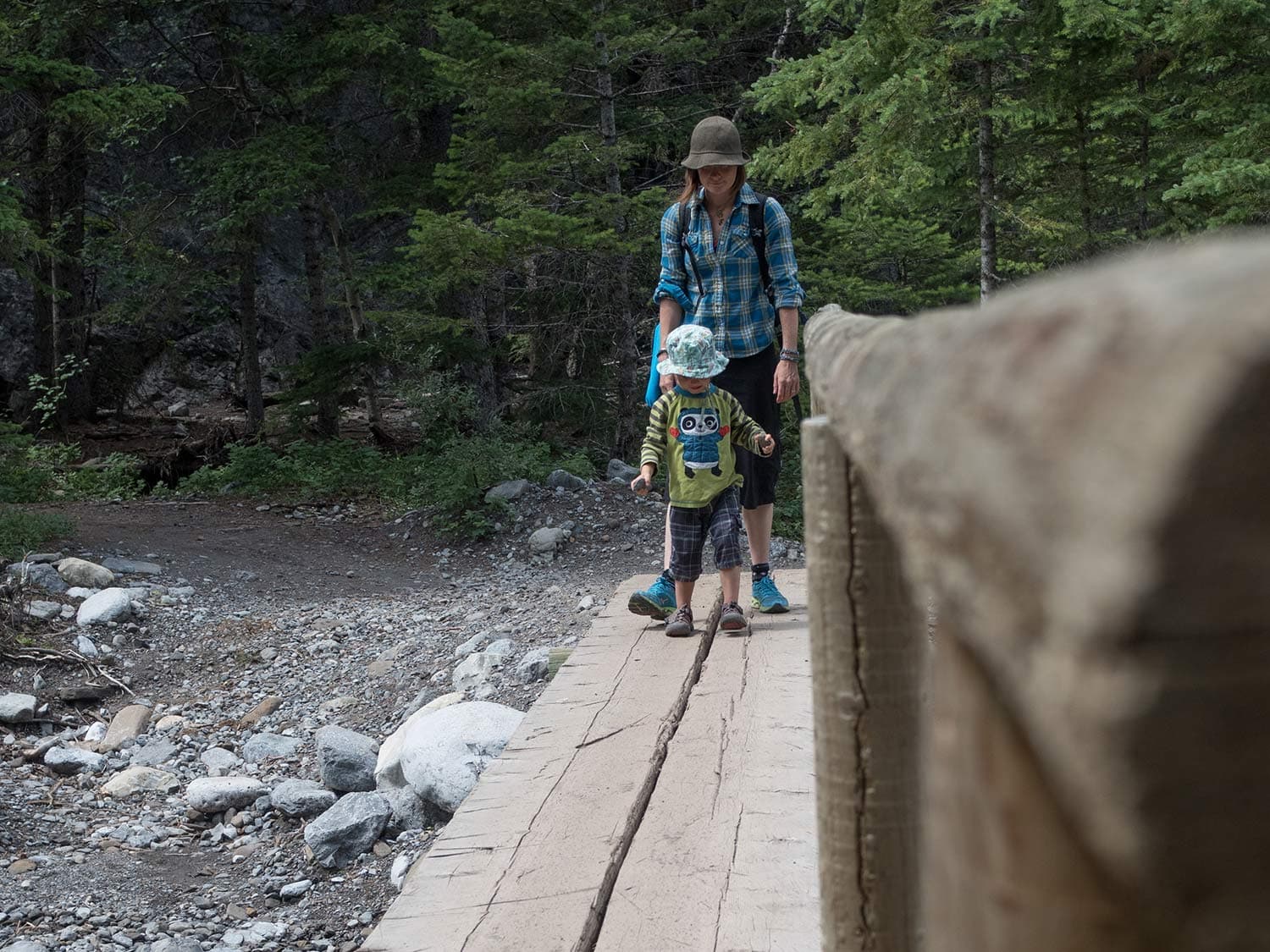 A mother and child walking on a board